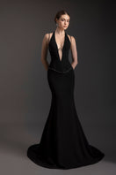 Elegant black halter gown by Le Thanh Hoa, featuring a flowing silhouette and stylish neckline, perfect for formal occasions.