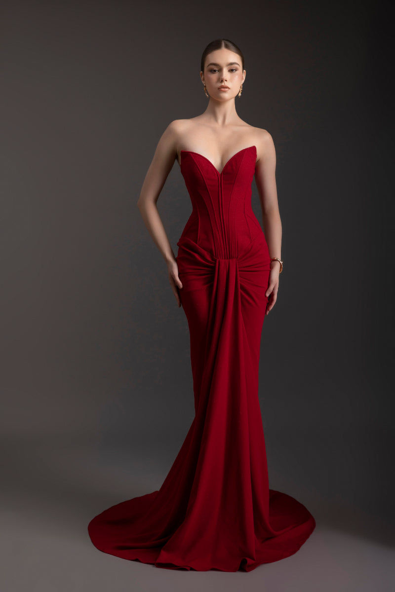 Elegant ruby red strapless gown by Le Thanh Hoa, flowing fabric and fitted bodice, perfect for formal occasions