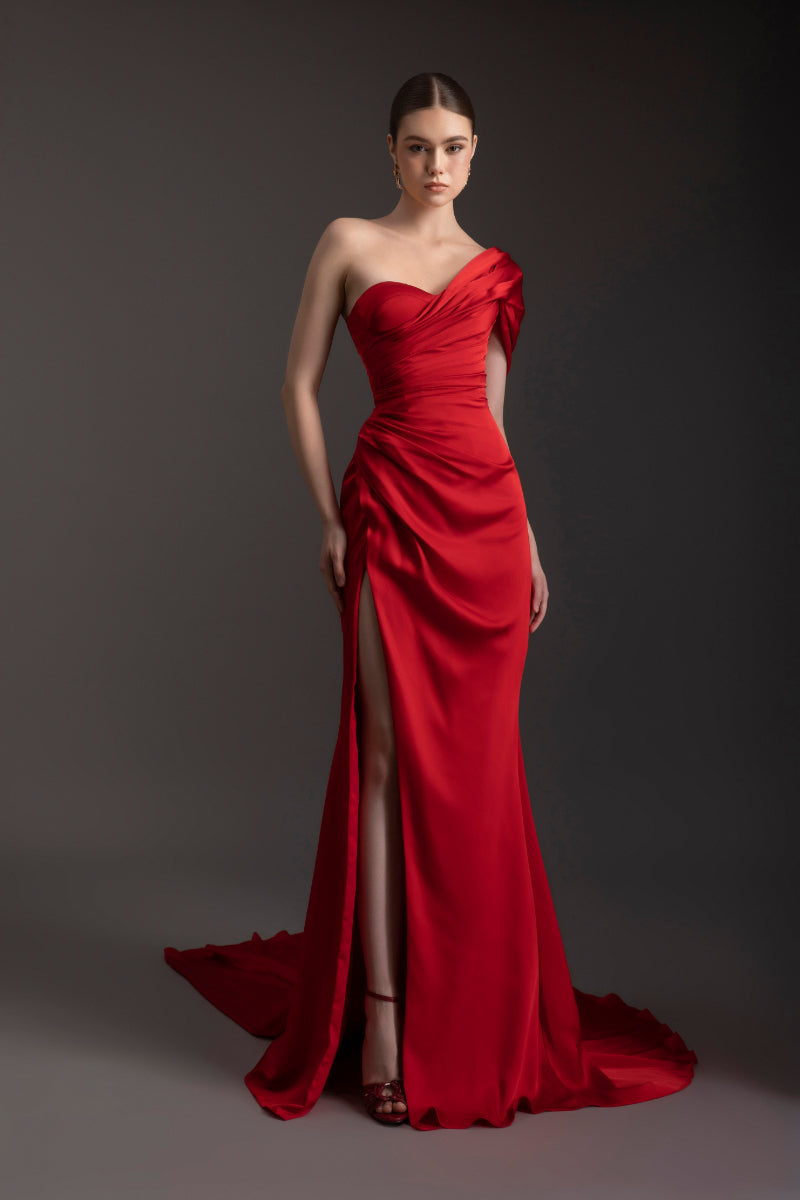 Le Thanh Hoa Ember Glow one-shoulder gown featuring flowing fabric and elegant design, perfect for formal occasions.