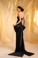 Elegant black peplum gown by Le Thanh Hoa, featuring a fitted bodice and flowing skirt, perfect for formal occasions.