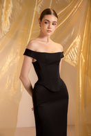 Elegant black off-shoulder gown by Le Thanh Hoa, featuring a flowing silhouette and sophisticated design.