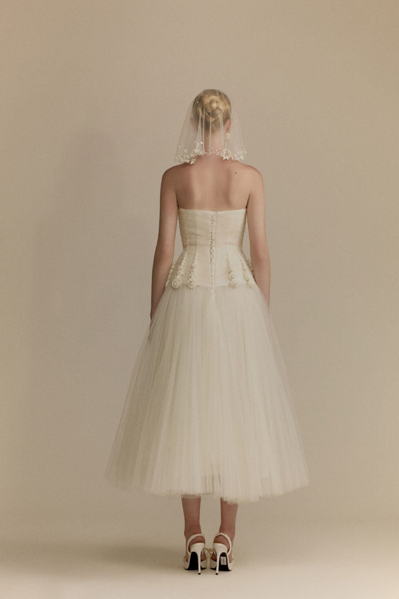 White Plan Anderson Dress gown featuring elegant fabric and classic design, displayed on a hanger.