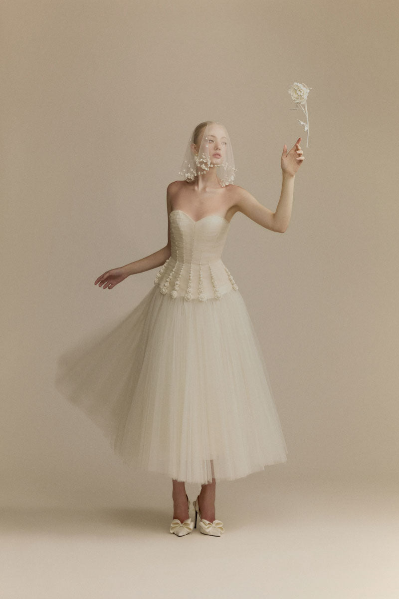 White Plan Anderson gown with elegant design, featuring flowing fabric and intricate details, perfect for formal occasions.