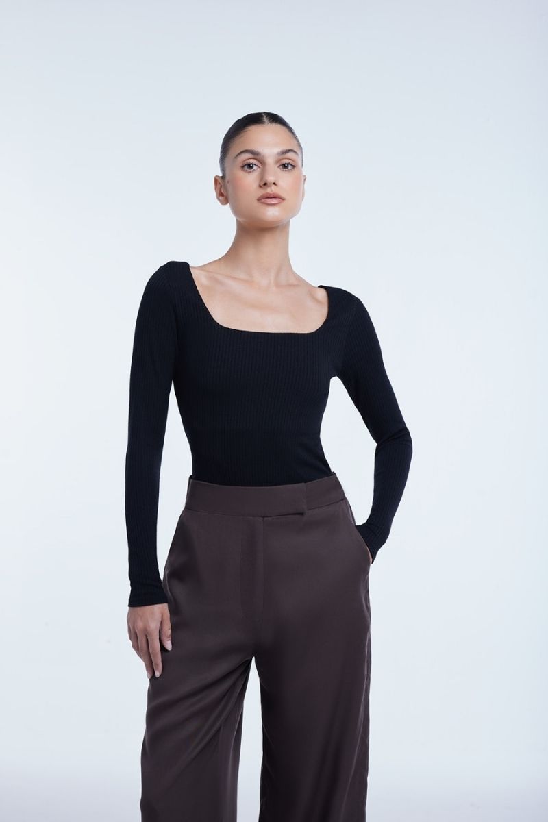 Dāl the Label relaxed wide-leg cropped pants in soft fabric, shown hanging with a focus on the loose fit and cropped length.