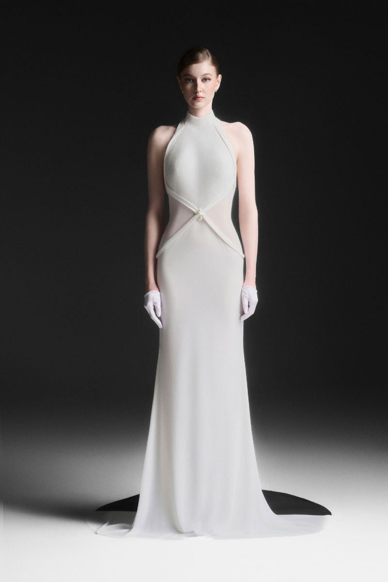 White Xantheir Mermaid gown by Maison Des Copains with a floor-length design, featuring elegant flowing fabric and a fitted silhouette.
