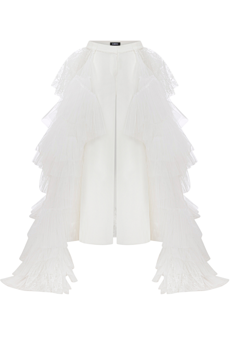 White crepe pants with ruffled train by Sudi Etuz, featuring wide-leg style and elegant, flowy fabric.