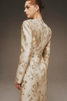 Elegant Margée Atelier Aurelia Brocade Gown with intricate floral patterns and luxurious fabric, displayed on a hanger.