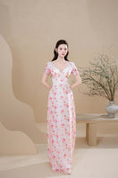 Elegant peach blossom gown by Do Long featuring flowing fabric and delicate floral details, perfect for special occasions.