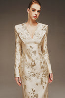 Elegant Margée Atelier Aurelia Brocade Gown featuring intricate fabric details and a flowing silhouette.