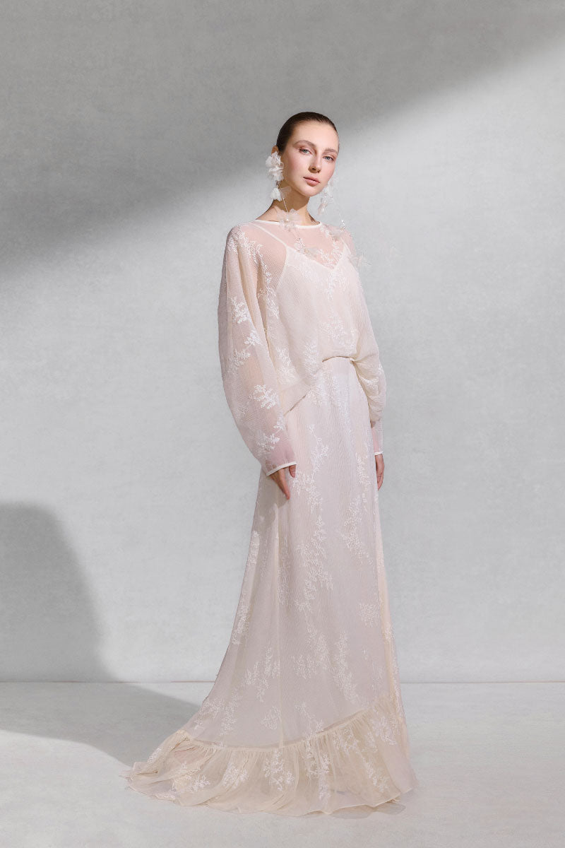 Arti Apparel Solara Maxi Dress in flowing fabric, with floral patterns and a V-neckline, perfect for summer occasions.
