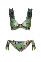Nur Karaata Blossom Bikini with floral pattern, featuring triangle top and matching bottoms, on a sandy beach setting.
