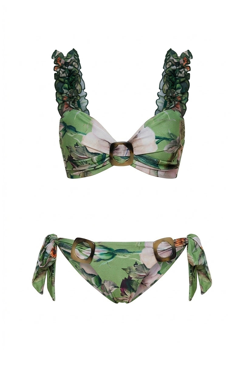 Nur Karaata Blossom Bikini with floral pattern, featuring triangle top and matching bottoms, on a sandy beach setting.