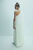 Nazlı Ceren Venus one-shoulder maxi dress in elegant blanche color, flowing fabric and stylish design perfect for formal occasions.
