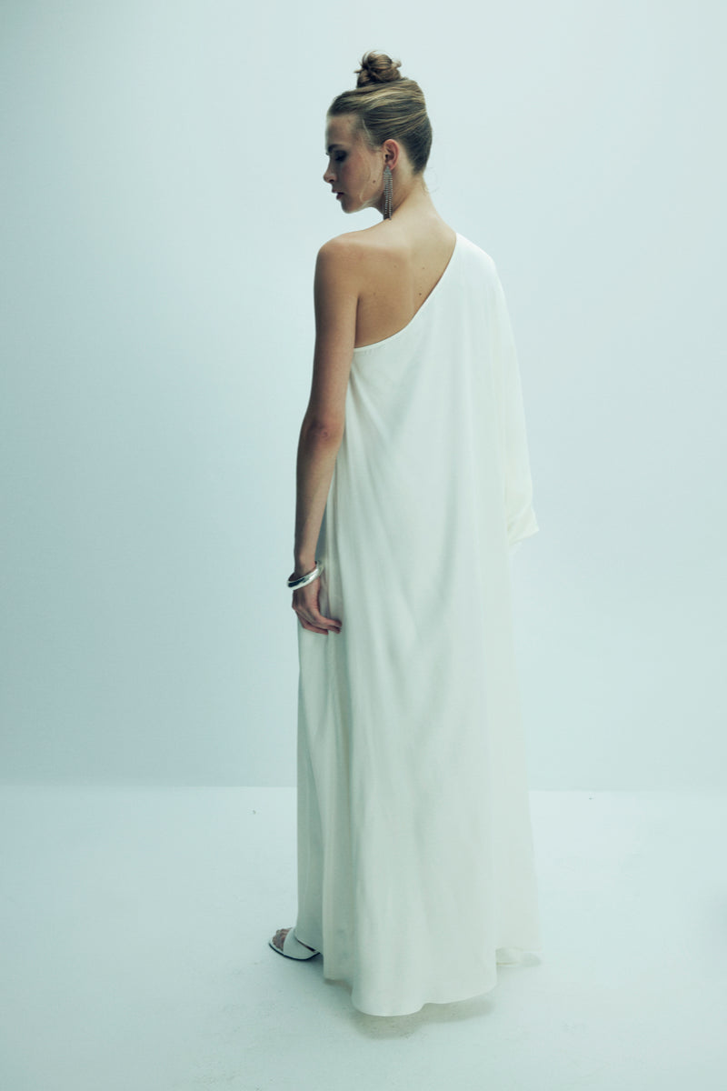 Nazlı Ceren Venus one-shoulder maxi dress in elegant blanche color, flowing fabric and stylish design perfect for formal occasions.