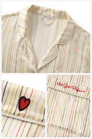 Multicolored striped Little Heart long pajama set for kids by Not Just Pajama, featuring soft fabric and playful design.