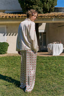 KIKI Cherry Cat 22 Momme silk long pajama set in cherry print, luxurious loungewear from Not Just Pajama, shown on a model.