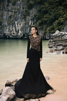 Black velvet satin gown with floral embellishments by Lune De Soie, featuring elegant draping and intricate floral details.