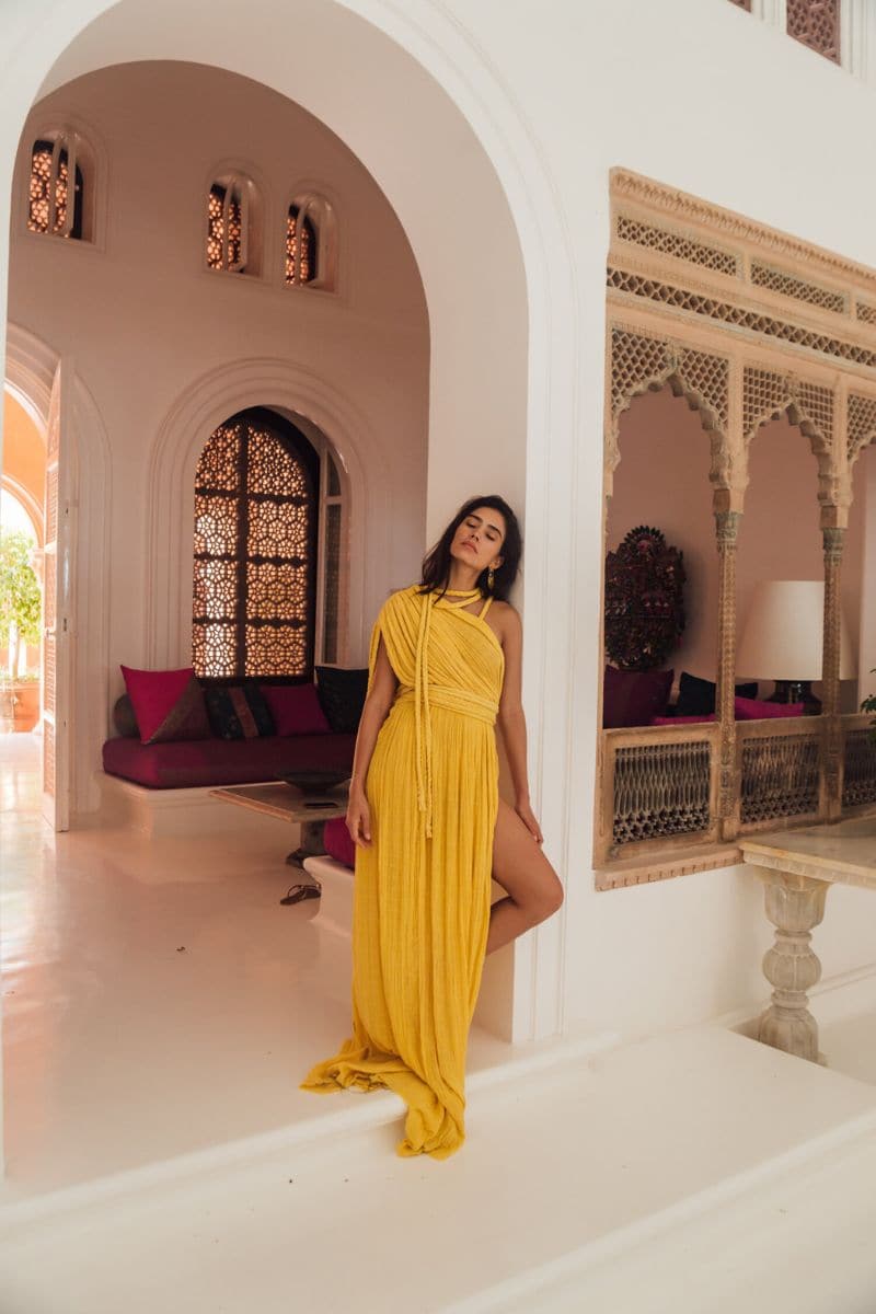 Kasia Kulenty Luna gown in Sol, a flowing maxi dress with vibrant sun-inspired patterns and elegant silhouette.