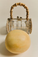 Waiwai Rio Alix Bambu Bag in Crystal, a stylish top handle bag with bamboo accents and transparent design.