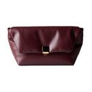 Rose de Mai Faye clutch in burgundy leather with sleek design and gold hardware, perfect for elegant evening outfits.