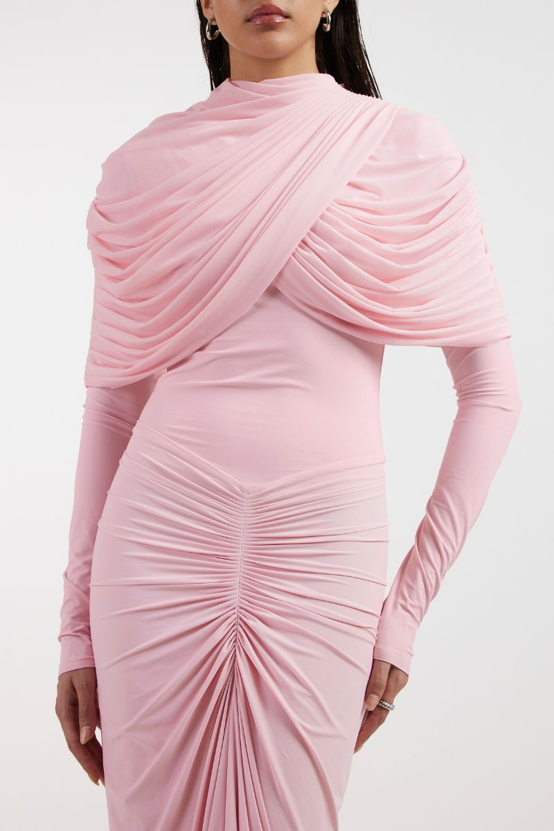 Deme By Gabriella NOA draped pink gown with flowing fabric and elegant design, displayed on a hanger.