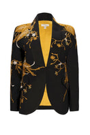 Nadya Shah Ines The Golden Age blazer in gold with structured fit and stylish lapels, showcased on a hanger.