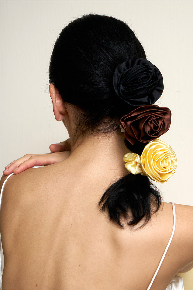 Soft pink silk scrunchies from Not Just Pajama's Tuscan Rose Hair Accessories collection, shown in a close-up image.