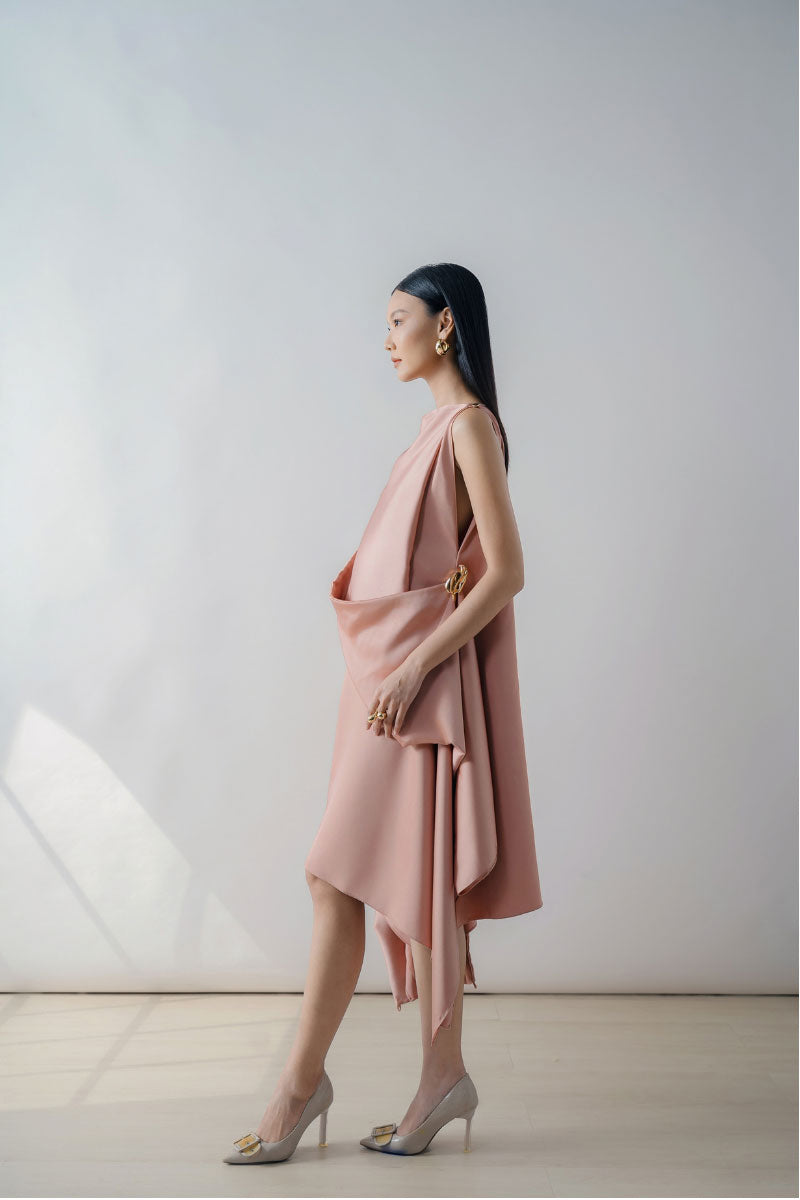 Rose pink draped sleeveless midi dress by DOC BAN featuring an asymmetrical hem and elegant, flowing fabric.