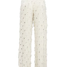 White beaded pants by Onalaja featuring intricate beadwork and a relaxed fit, displayed on a model.