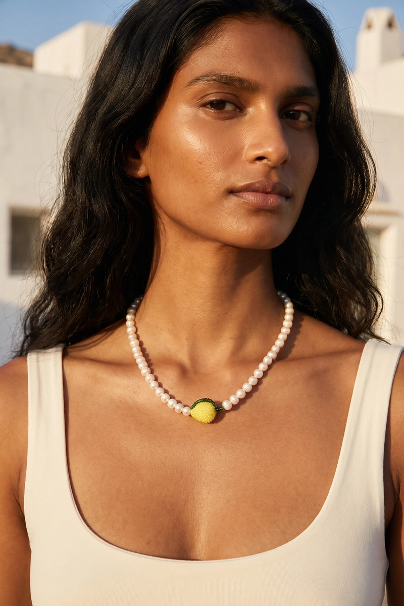 Pura Utz Pearl Lemon Necklace featuring a string of pearl and lemon-shaped beads on a delicate chain.