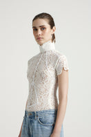 Deme By Gabriella Florence off-white top with long sleeves and a relaxed fit, styled casually.