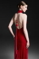 Red Zafielle halter floor-length gown by Maison Des Copains displayed on a model, featuring elegant design and flowing fabric.