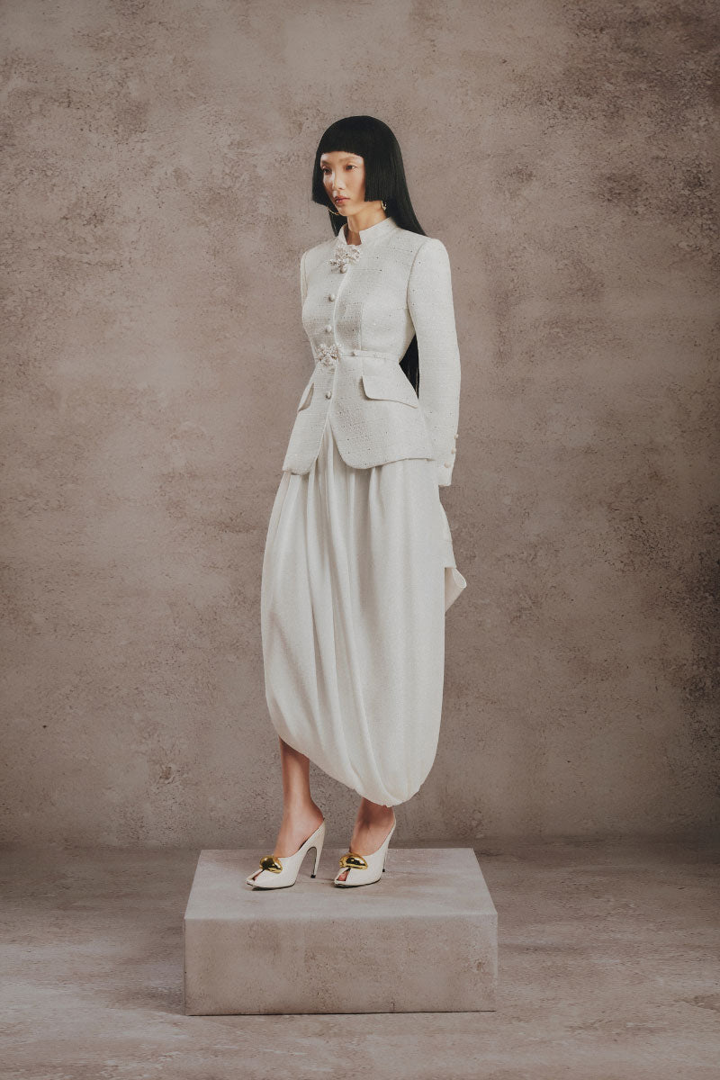 Ivory sculpted co-ord set by White Plan featuring fitted top and matching high-waisted pants, displayed on a model.