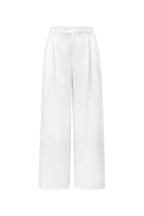 White JEMMIA pants by Arti Apparel, featuring a relaxed fit with pockets and stylish design, shown on a model.