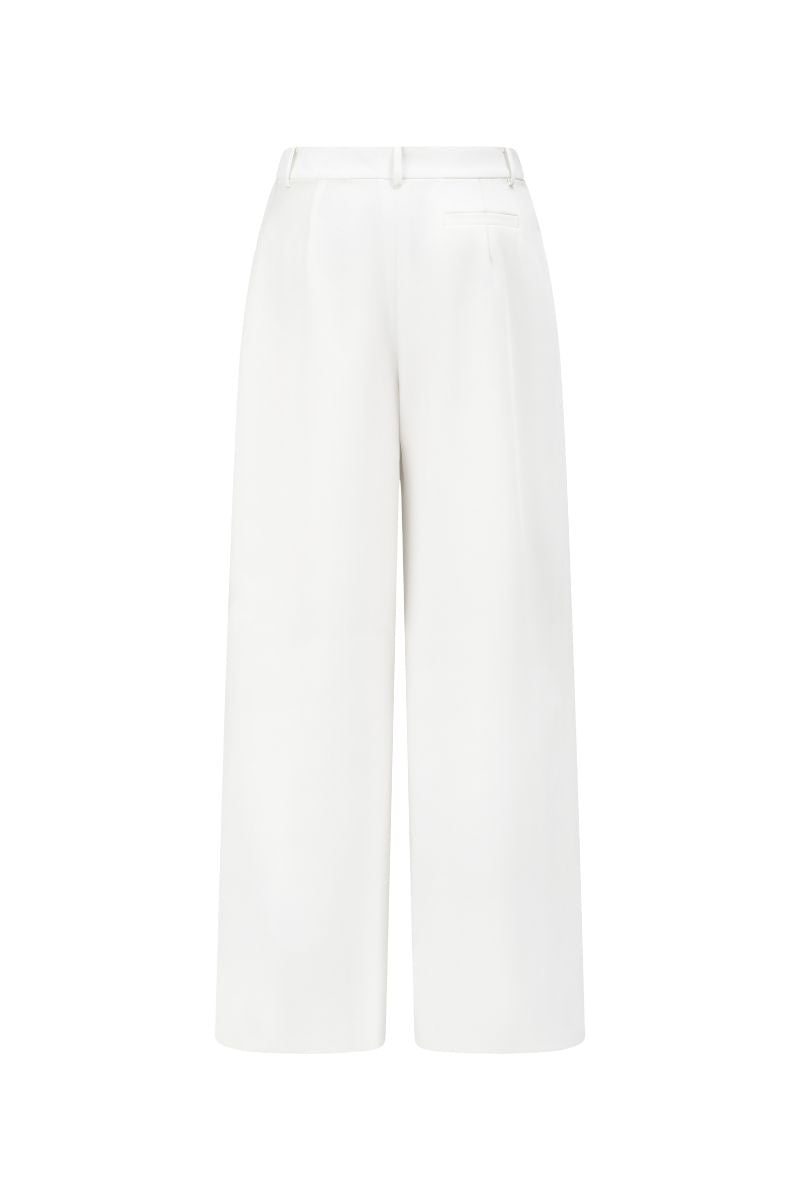 Arti Apparel JEMMIA white pants, fitted with a high waist and sleek design, shown on a model.