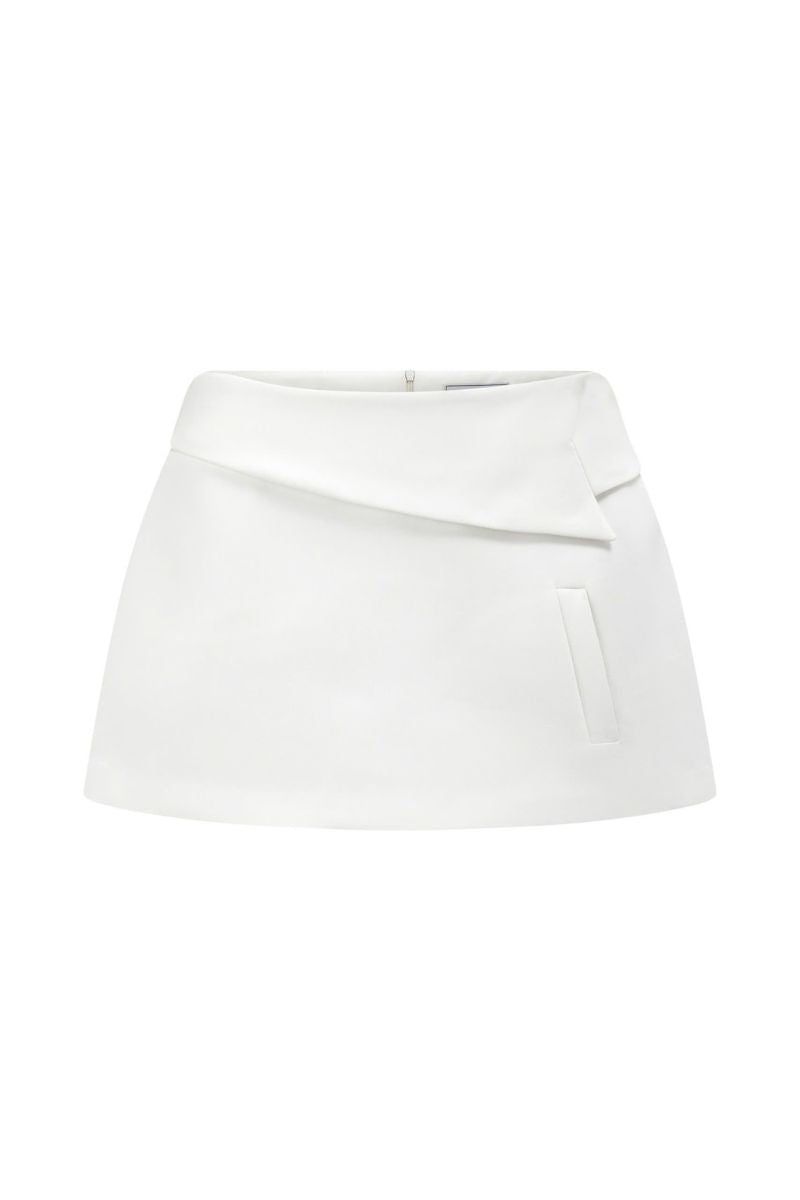 White Ontario mini skirt by Arti Apparel hanging on a clothing rack, showcasing its sleek, fitted design.