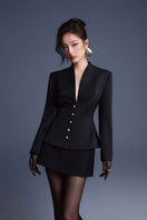 Black folded buttons top by Keira Tong, featuring a stylish design with folded button details and a fitted silhouette.