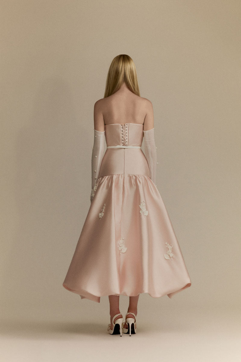 White Plan Lumi Pink gown featuring elegant flowing fabric and a stylish design, perfect for special occasions.