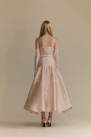 White Plan Lumi Pink gown featuring elegant flowing fabric and a stylish design, perfect for special occasions.