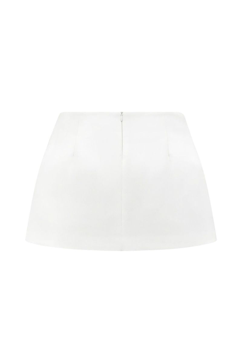 White Ontario mini skirt by Arti Apparel, stylish and fitted, shown on a model with a clean, modern background.