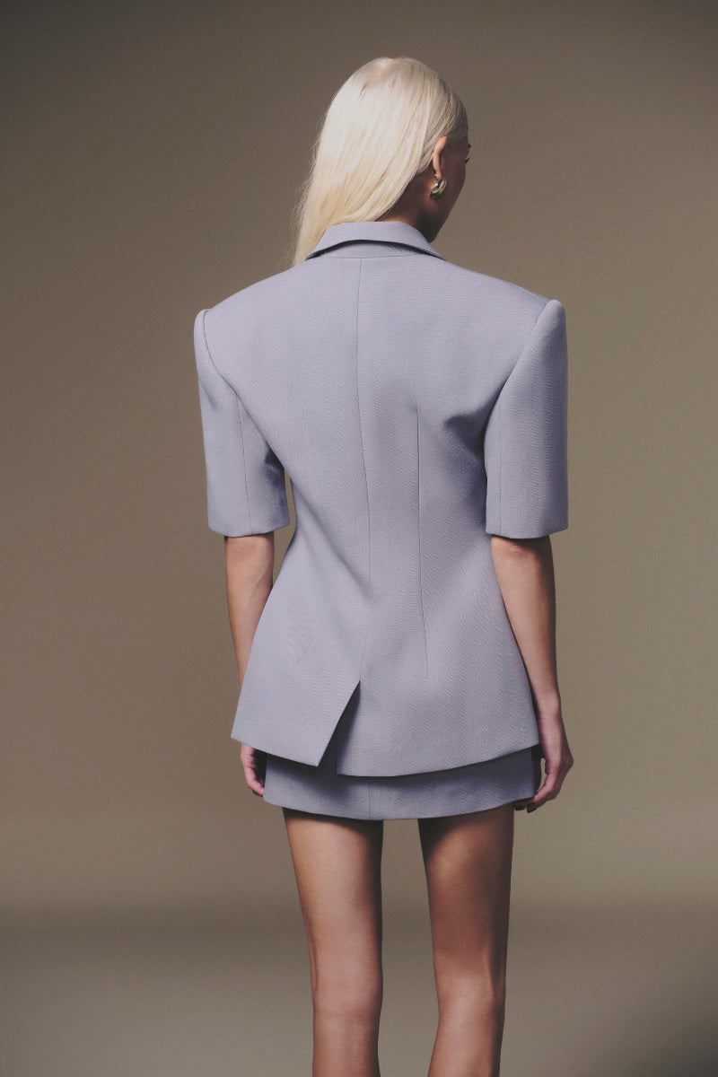 Grey short-sleeve blazer by Keira Tong, tailored fit with lapels and front button closure, displayed on a mannequin.
