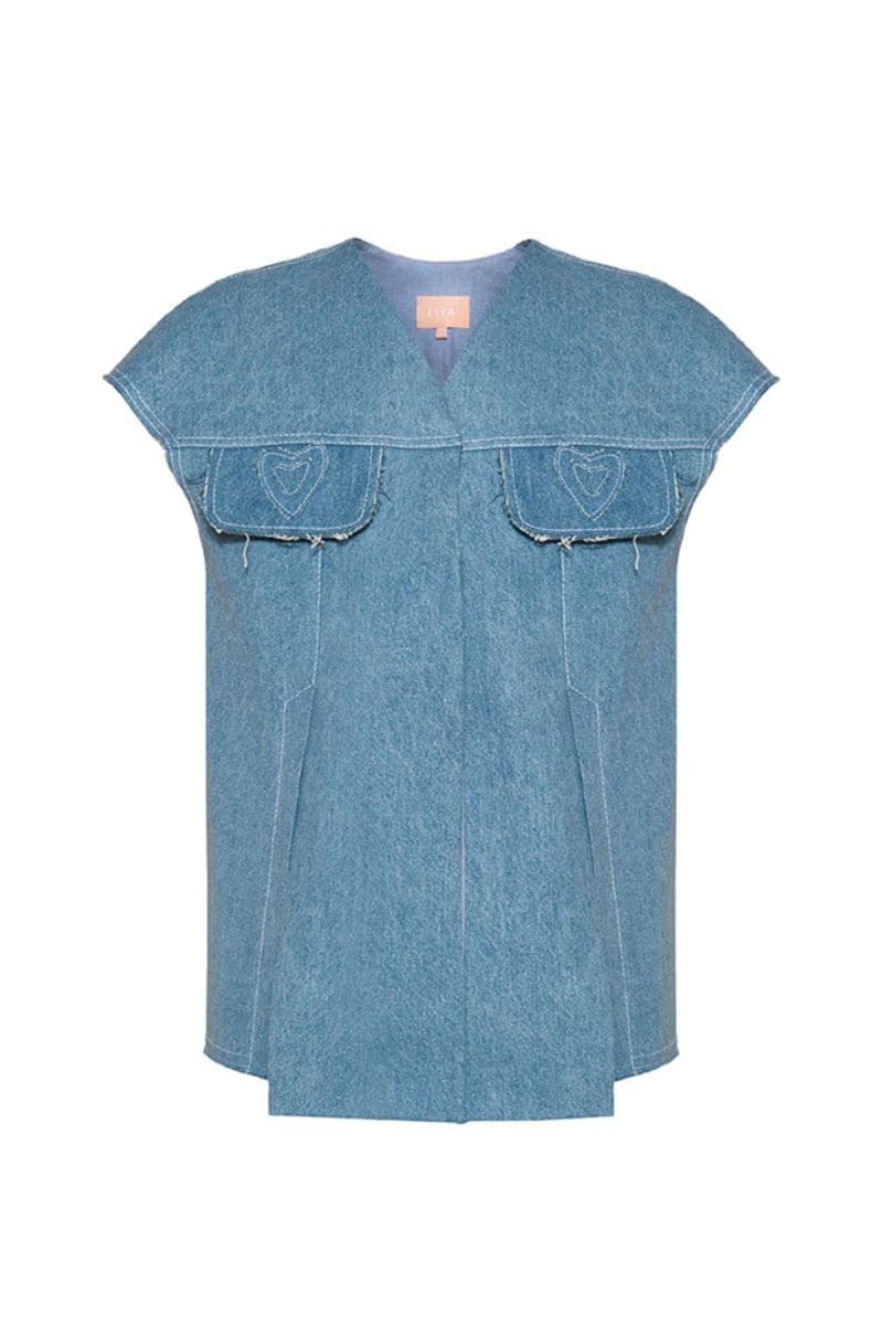 Liya Heartscape denim vest with front button closure and chest pockets, stylish and casual sleeveless denim vest for women.
