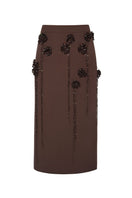 Lalo maxi skirt with knitted flower embellishments, featuring a pencil silhouette and elegant design.