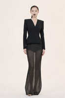 Nihan Peker Bobo long sleeve gown with flowing fabric and elegant design, displayed on a mannequin in a neutral setting.
