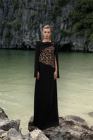 Black velvet satin boat neck gown by Lune De Soie, featuring a smooth, elegant design with a flattering boat neckline.