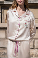 Soft blush pink silk pajama set by Not Just Pajama, featuring long sleeves and a relaxed fit for comfortable sleepwear.