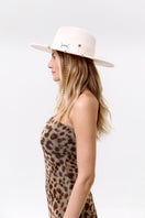 Le Sh Ka Ecru Gold London hat with 24K gold-plated accessories, stylish beige hat featuring elegant gold accents.