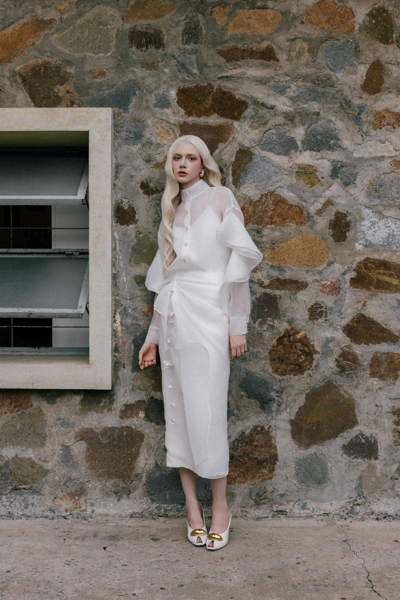 White Plan Lindsay shirt and bone co-ord skirt set, featuring a stylish white shirt and matching bone skirt laid flat.