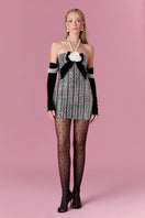 Nur Karaata Vivienne Rose mini dress displayed on a hanger, featuring a floral pattern and lightweight fabric.