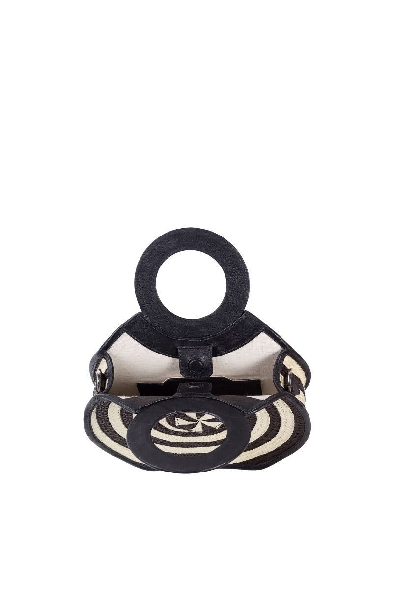 Adriana Castro Zenú mini raffia and leather top handle bag in black with woven raffia accents and sleek leather details.